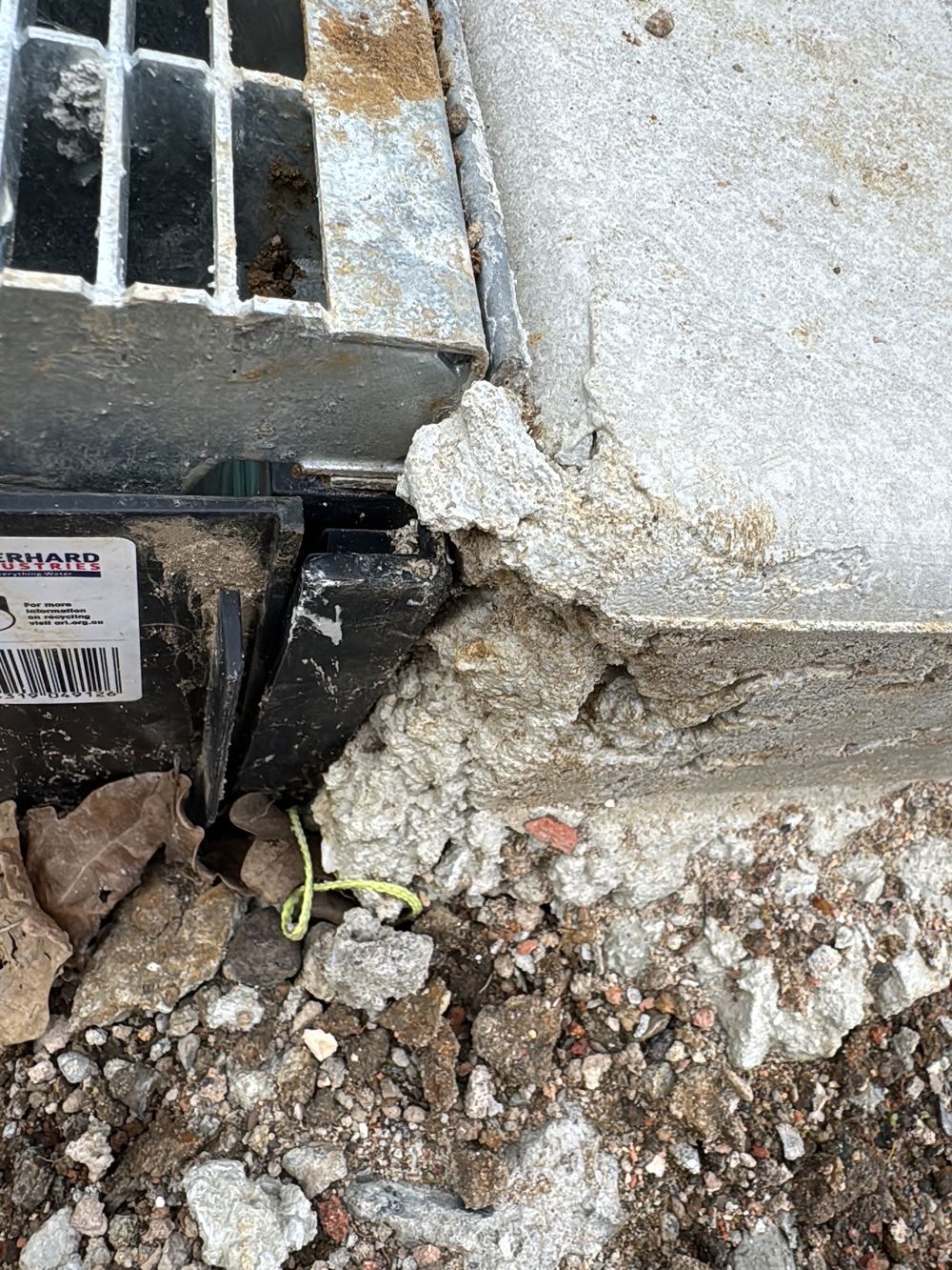 No isolation joint between the driveway concrete and a pit grate, recorded during a defect investigation in Ermington