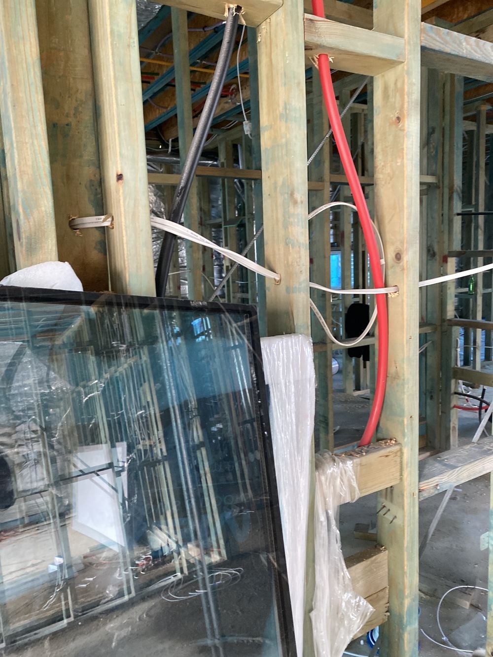 Electrical cables against hot water pipework, inside the 25mm separation required, found during a lock-up inspection in Gables