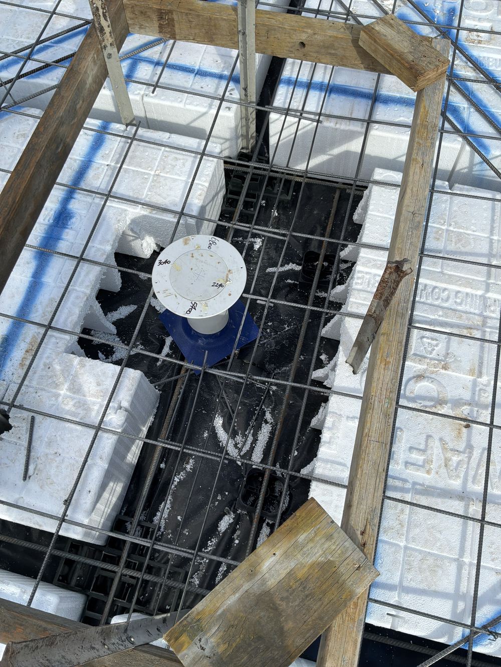 Trimmer bars missing around a service penetration where the top mesh was cut, found during a slab pre-pour inspection in Gables